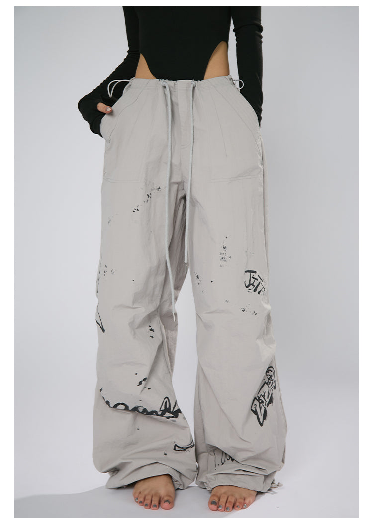 AN JITT's graffiti print work pants for women in spring and summer feature a jazz-inspired new American style with loose black dance pants.